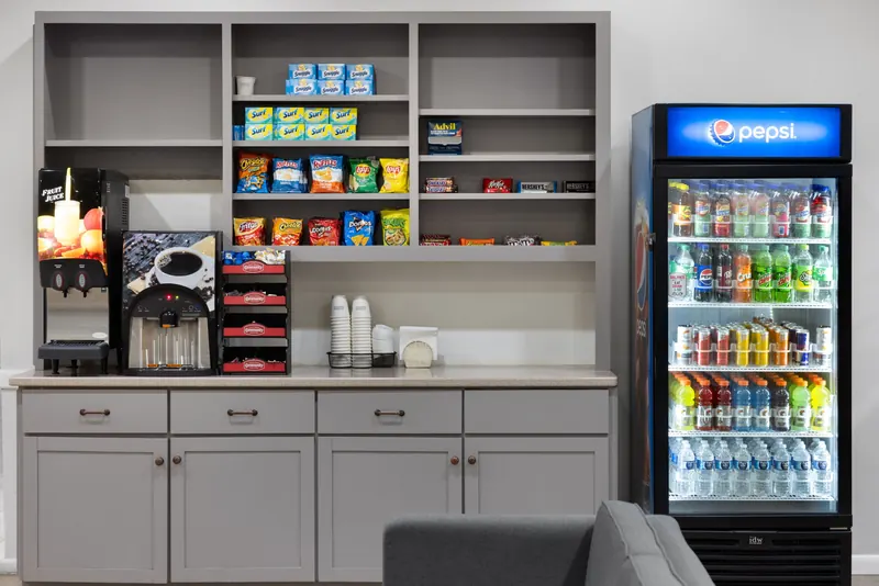 Coffee machine, juice dispenser, snacks and a cooler of cold drinks in the lobby